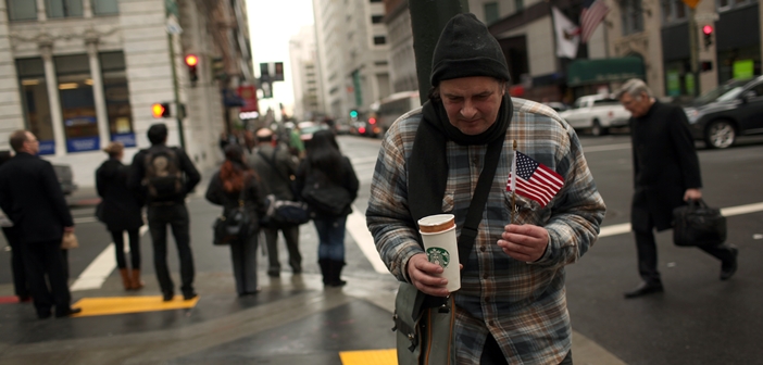 Homeless man begs for money in the Financial District in San Francisco